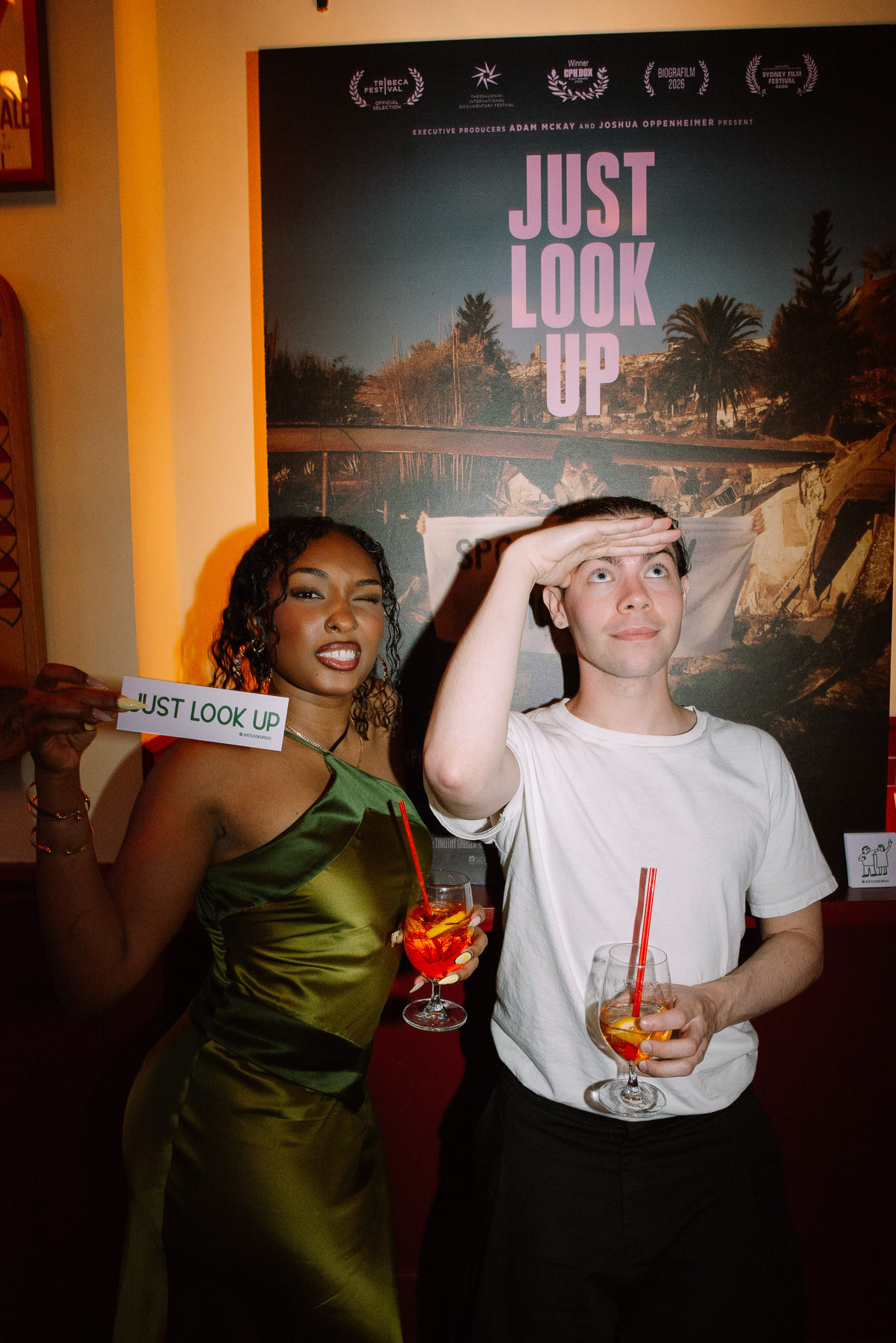 Guests holding a Just Look Up sign