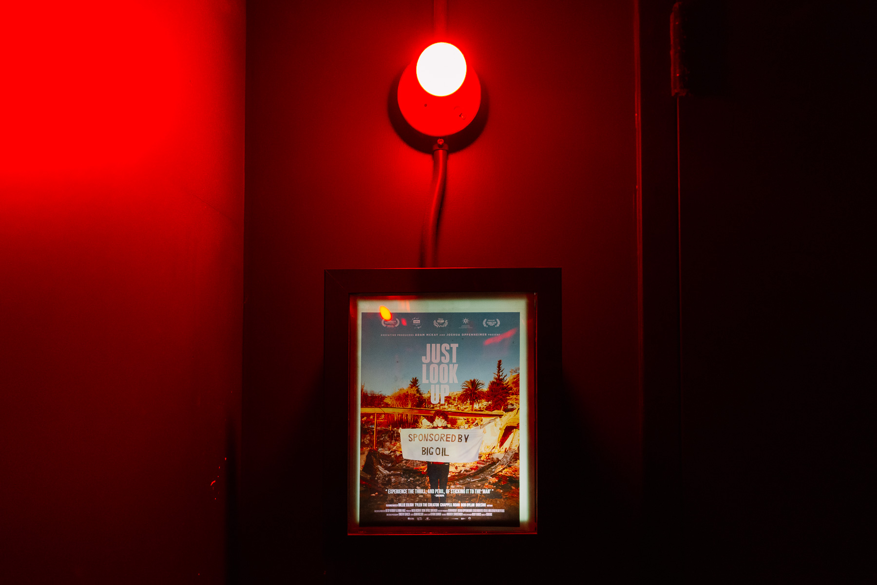 Just Look Up poster lit by a red lamp