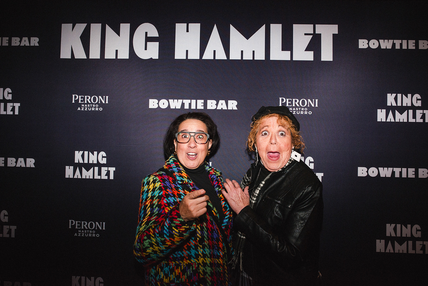 Guests making playful faces on the King Hamlet step-and-repeat
