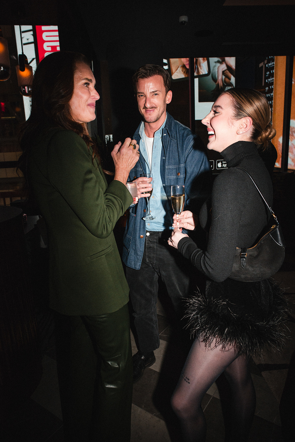 Guests laughing together with champagne