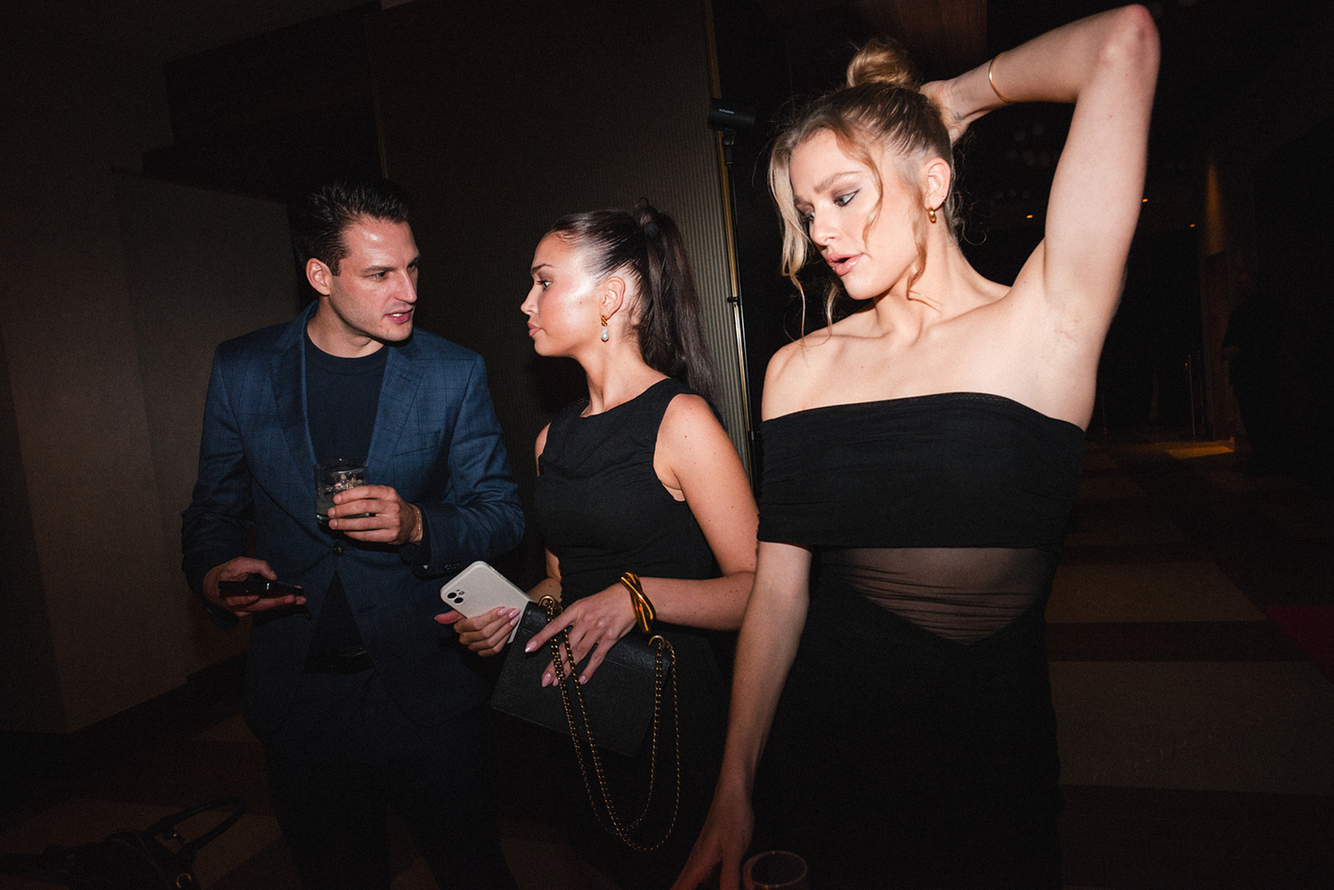 Three guests in eveningwear at the afterparty