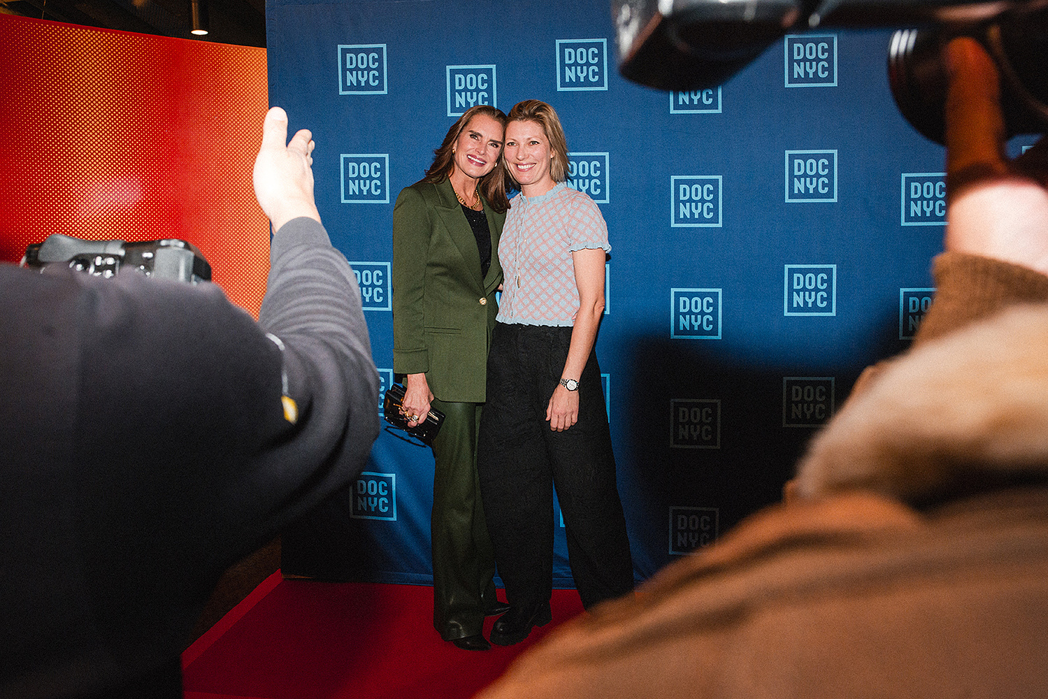 Guests posing on the DOC NYC step-and-repeat