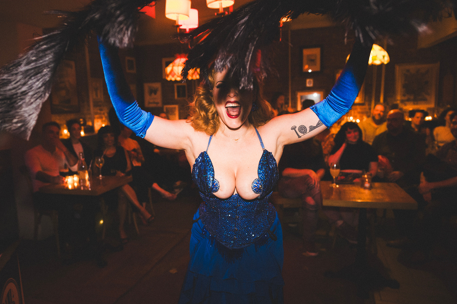 Performer with feather fans under the chandelier