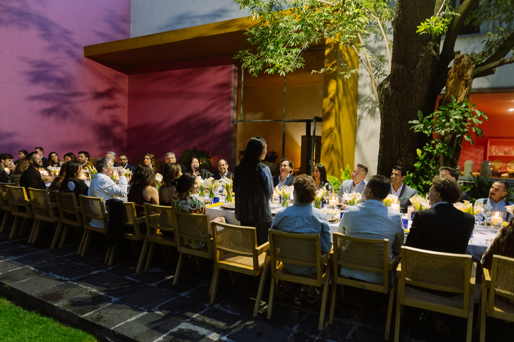 Long table dinner with a speaker standing