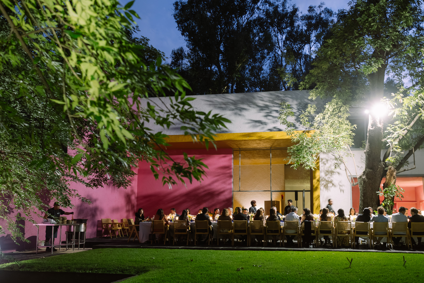 Long table dinner at dusk from the lawn