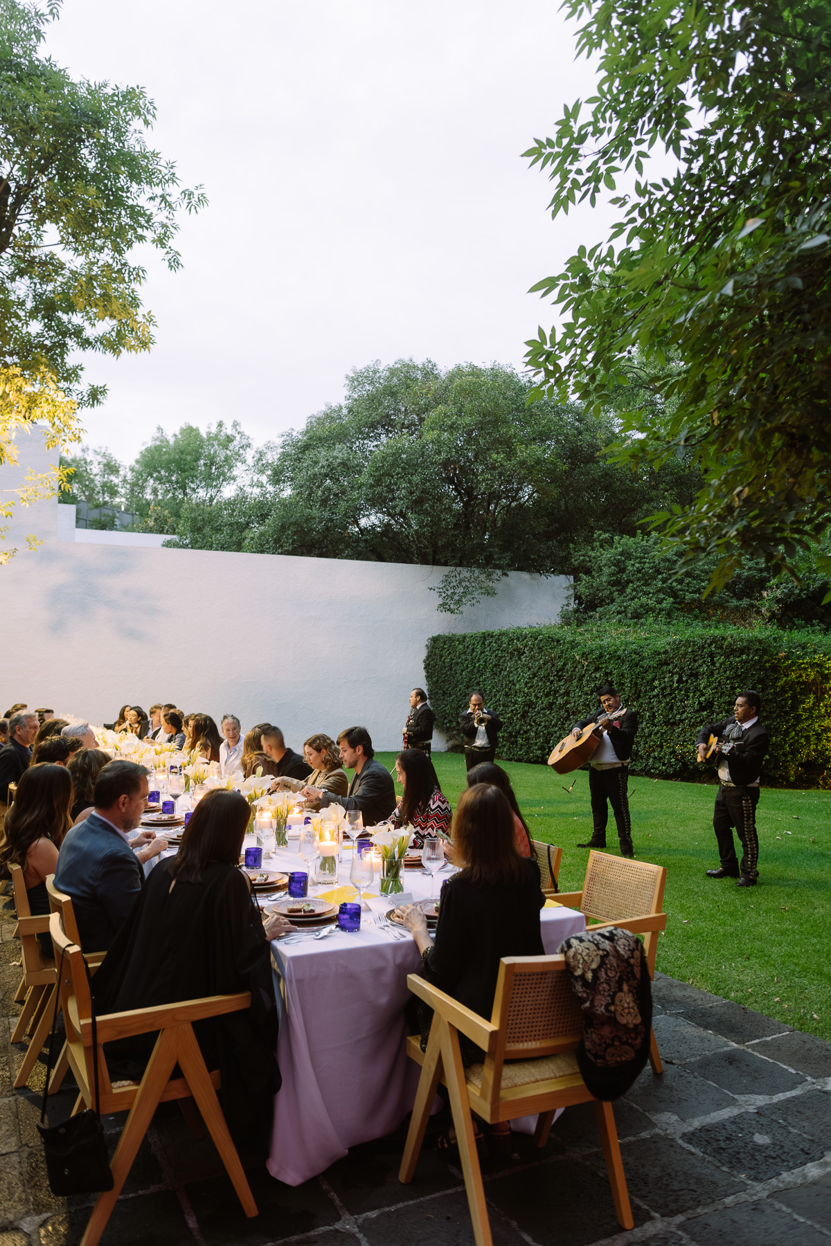 Long table set on the lawn at dusk